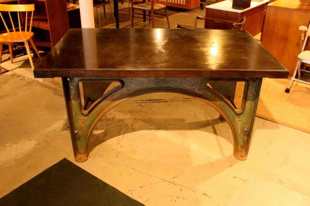 A wonderful example of American design for Industry. A warm dark patina to the steel top and the original painted finish to the base makes this table not just a functional table but a real work of art.