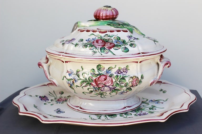 Ceramic Soup Tureen in manner of Marseille featuring Pink, Purple and Green decor of natural flowers. Cover grips on Lid are decorated with onion, asparagus as well as painted flowers.