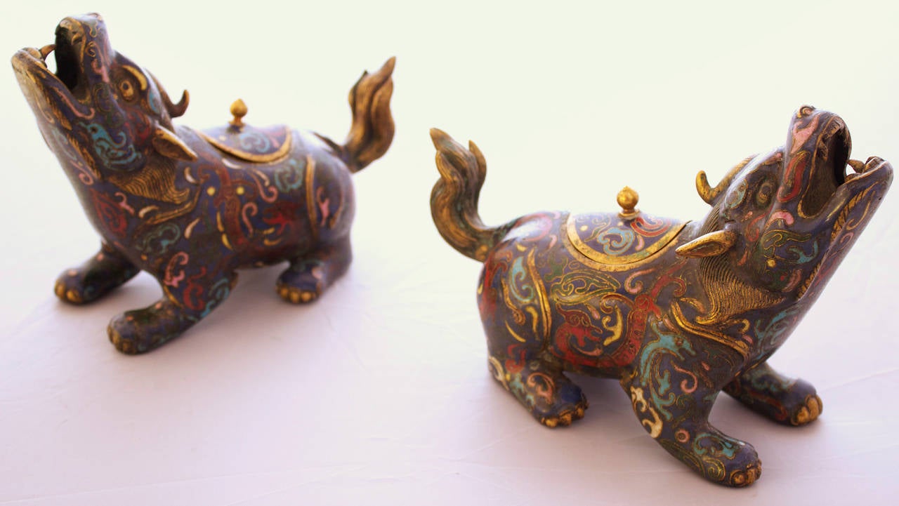 Late Qing period crouched mythical creatures in a gorgeous cloisonné having vibrant colors and a little lid on their back to introduce the incense when fumes (smoke) comes out of the open mouth.