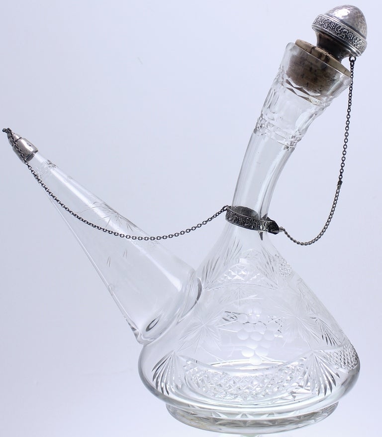 Stunning and exceptionnaly rare is this 19th C. crystal wine Decanter.It was made before the advent of glass machine production! .It was handblown,hand engraved and hand cut..The Decor is wine grapes and foliage.The 2 cork stoppers are mounted with