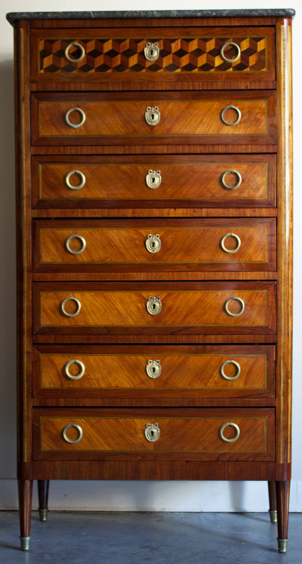 Highly decorative and wonderful marquetry on oak work for this seven banded drawer’s semainier (semaine in French is a week i.e. 7 days) made during Napoleon III period.\The top drawer shows an exceptional marquetry of cubes (front and sides) made
