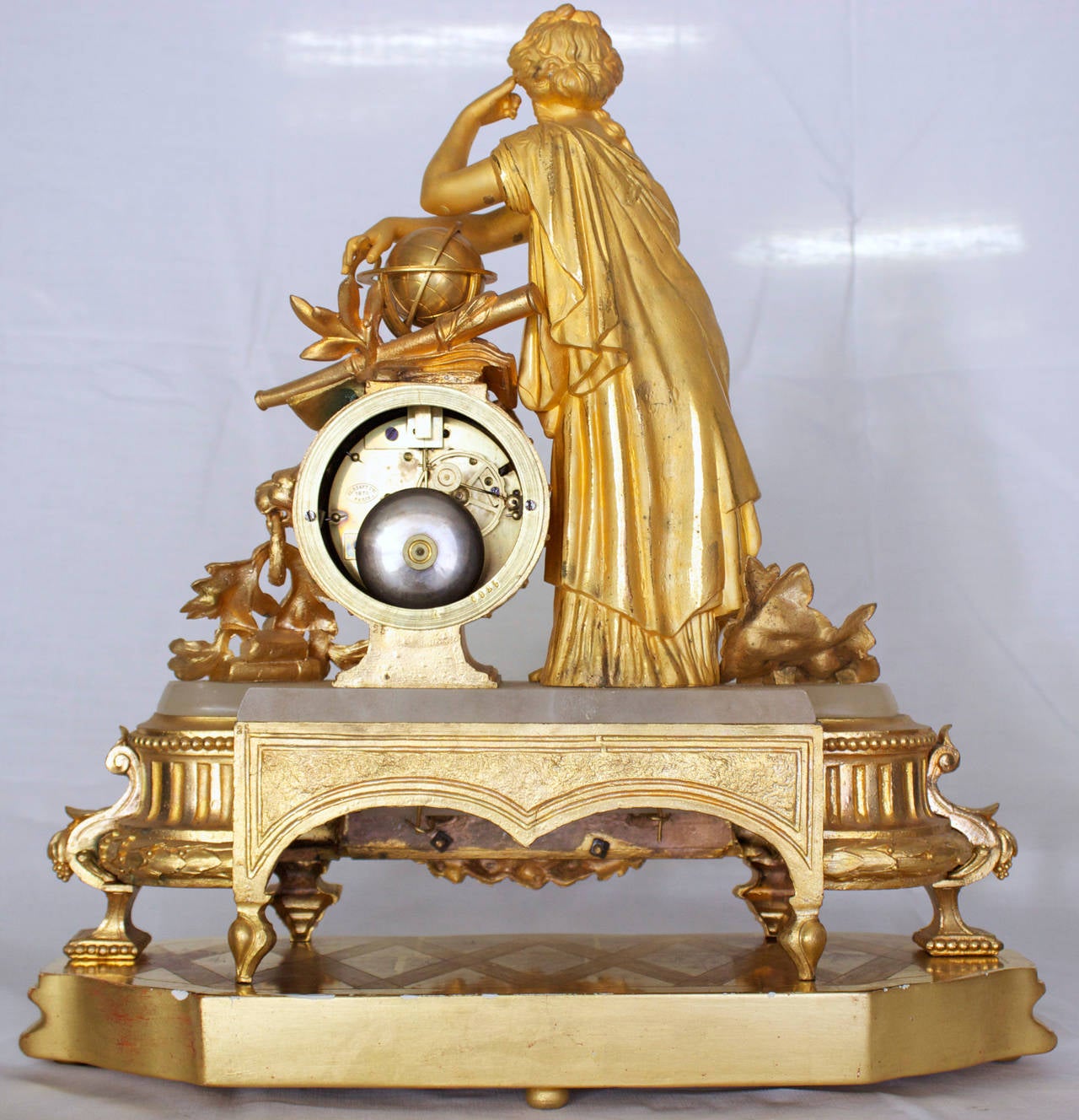 Magnificent clock in chased and ormolu bronze representing Urania ,daughter of Zeus ,an allegory of Astronomy and Astrology (the Greek did not differentiate).The Muse is dressed a l'Antique and is represented thinking with a finger of the left hand