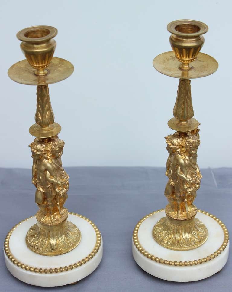 Each is representing three bronze doré cherubs draped 