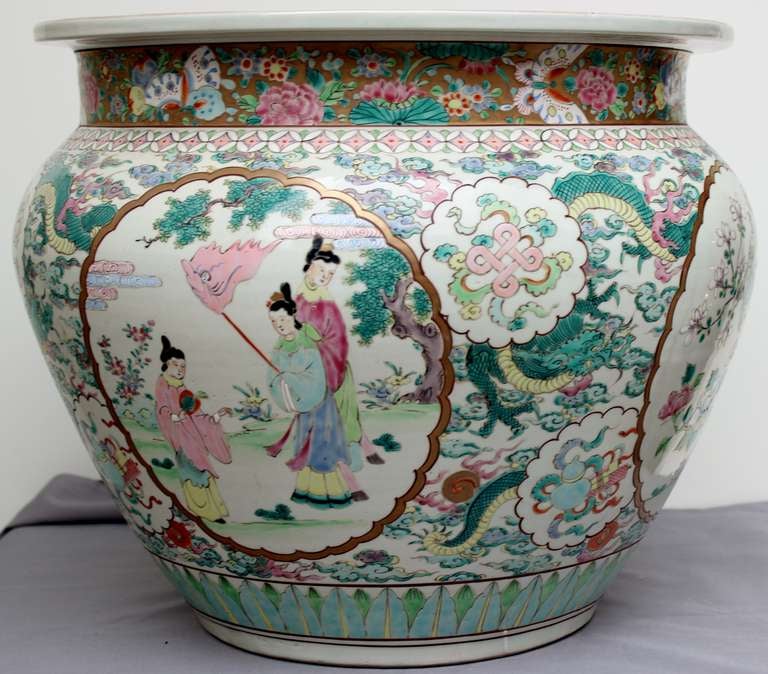 Gorgeous underglazed hand decor for this large  Fish Bowl  with 4 gold circle registers.Two are showing each 3 women wearing different and colorful clothes  and having separate occupations.The 2 others have each 2 birds on a branch surrounded by