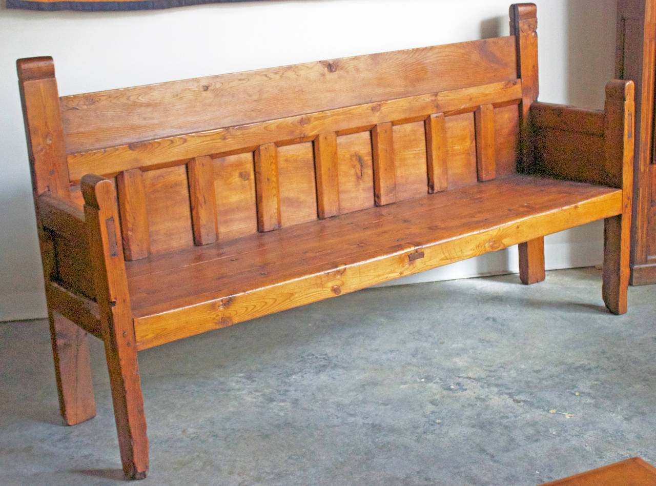 Great bench made entirely in pinewood in the French Pyrenees, early 19th century. The large studs on the seat were handmade.