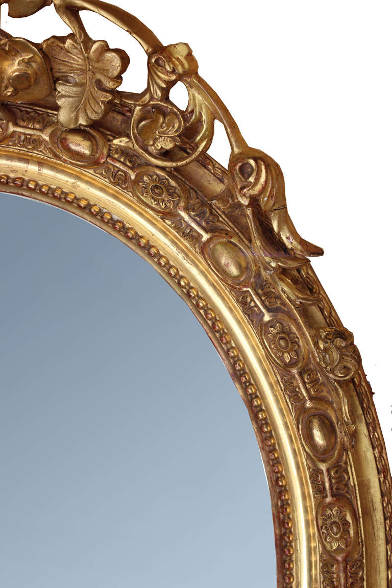 Excellent proportions and condition for this beautiful Louis XVI style oval mirror made during Emperor Napoleon III period.
Frame is wood and decor made of musical instruments, quiver, rake, pompons and leaves on top and bottom as well as 