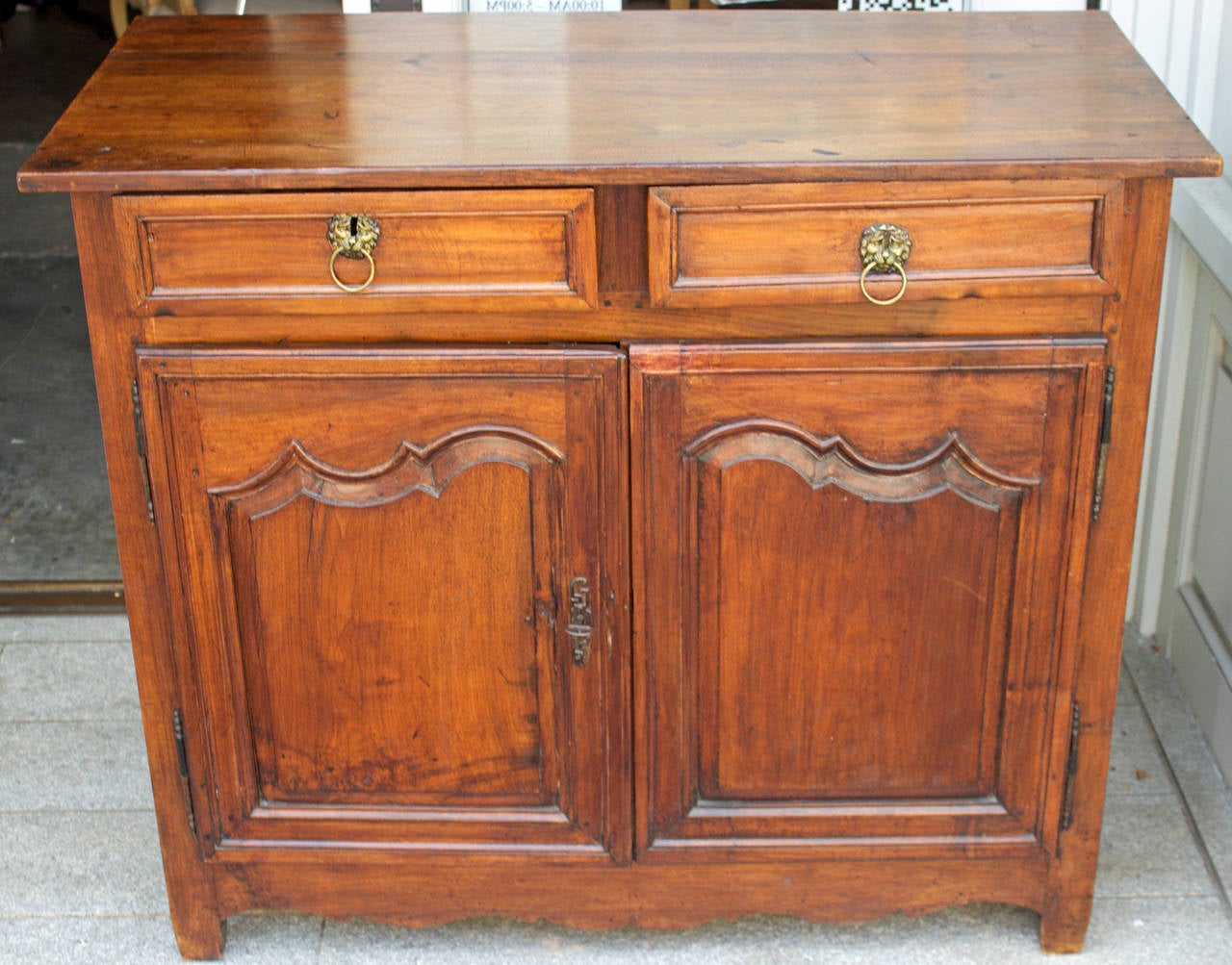 Very Provincial Louis XIV buffet, in solid walnut with two drawers under the wooden top and two paneled doors. Nice hand carving and elegant asymmetric deep door moldings with curves “a ressauts”. Rest on straight feet in line with the front posts,