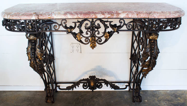 French wrought iron and marble-top console table,
France, circa 1870, Napoleon III style.
Truly gorgeous console from the end of 19th century having outstanding black patinated scrolls of wrought iron work on the cincture, the two front legs and