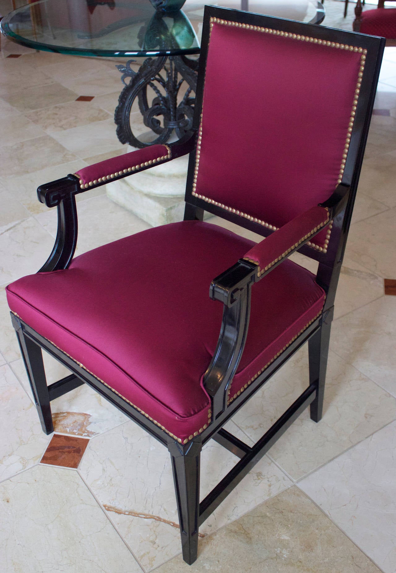 Neoclassical armchair in black lacquer with a square back and a H-shaped stretcher. Silk fabric with brass head nails.
