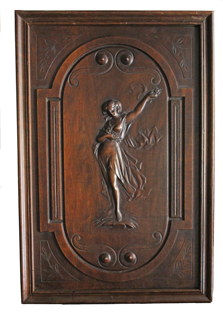 Great Carving of Two solid Walnut
 panels typical of Art Nouveau Panels. One representing a Muse with Dragon Fly wings and collecting flowers. The other represents a dancing Muse with Flowers in her raised left arm and holding a belt made of Flowers