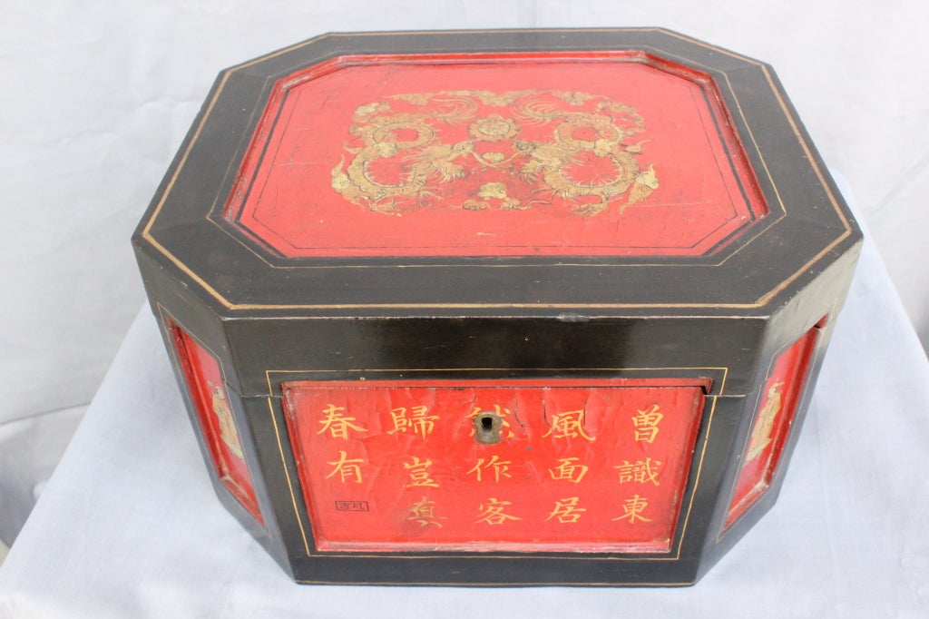 Chinese Export Tea Chest in Red and Black Lacquer, painted in Canton Style with Chinese Characters and Dragons. Interior has two carved Pewter Canisters  China Ca. 1870