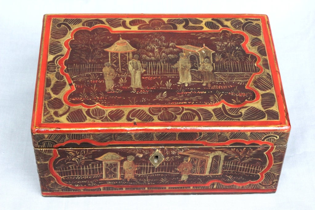 A Chinese Export Tea Chest, In lighter and darker Reds and with scenes of people in a garden atmosphere with pagodas painted in gold. Pewter insert is carved with people and foliage and has an Ivory pull China Ca 1830-1870