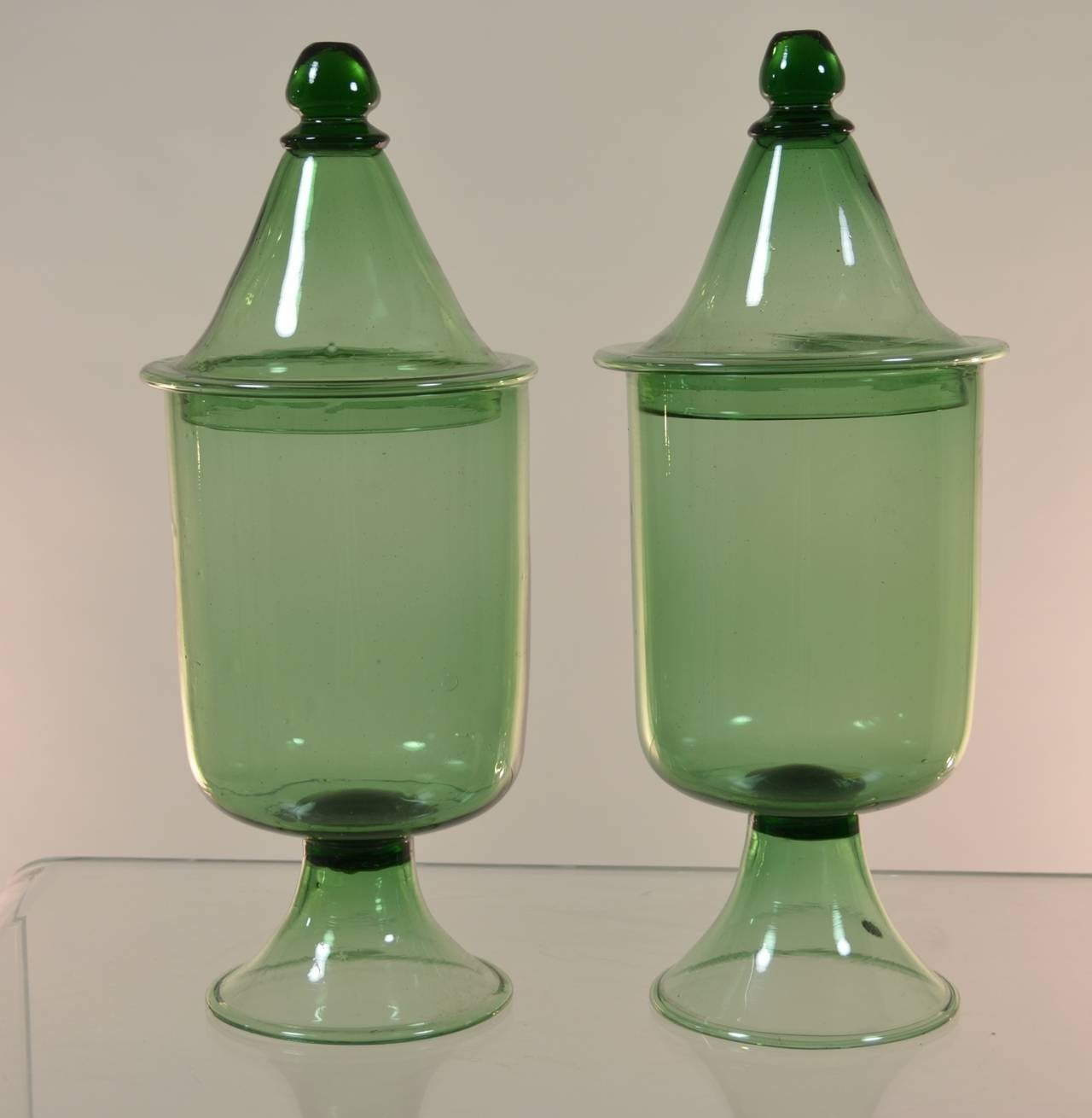 Charming pair of lidded jars. Rustic seeded green glass. Hand blown. Made in Italy sticker remains on one jar.