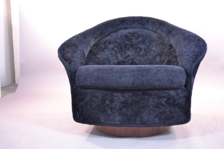 A comfy swivel and tilt armchair by Adrian Peasall. Orignal faux furn upholstery and walnut base.