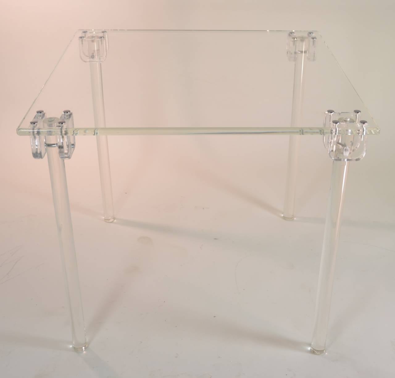 Wonderfully crafted Lucite folding card table. Cylindrical legs that fold neatly along the edges of the table --then fold down and snap solidly into place pegged into the heavy Lucite tabletop. Excellent condition.