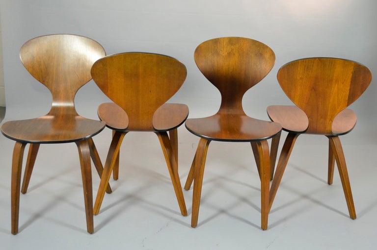 Walnut side chairs by Norman Cherner for Plycraft --these are all ealy. Featuring a fine walnut finish with ebonizesd details.