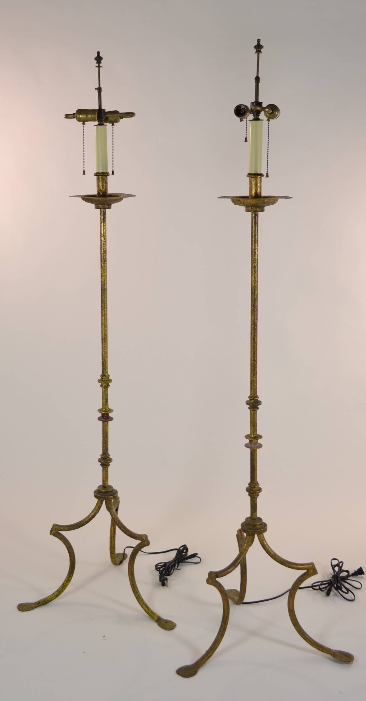 Pair of Mediterranean-style floor lamps in gilt finished iron. New wiring. Circa 1950s. Lamps are 18