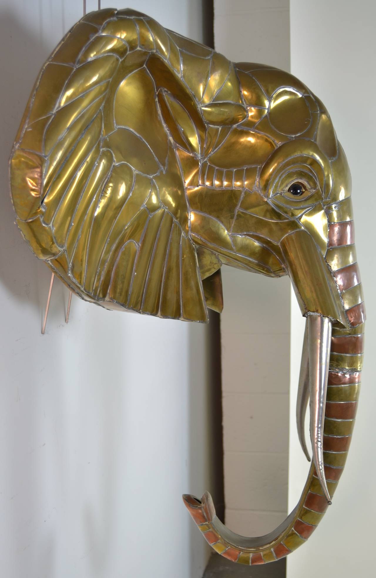 Charming elephant sculpture in brass, copper and tin with glass eyes. Wonderful size and presence. Minor damage to back side of of one ear.