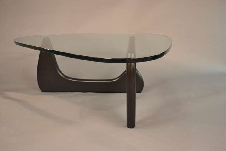 Iconic Noguchi table --this is an early issue. Note hallmarked pin illustrated. Original glass on two part ebonized base. 