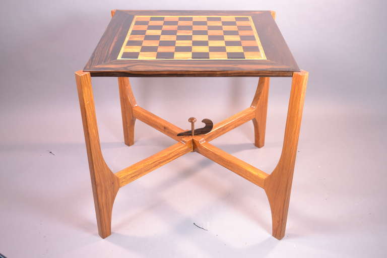 Chess board made from inlaid rosewood and teak with a beautiful high gloss finish nested into a stand that can be disassembled by removal of the decorative rosewwod center pin. The base is made of two separate pieces but very sturdy. Beautiful