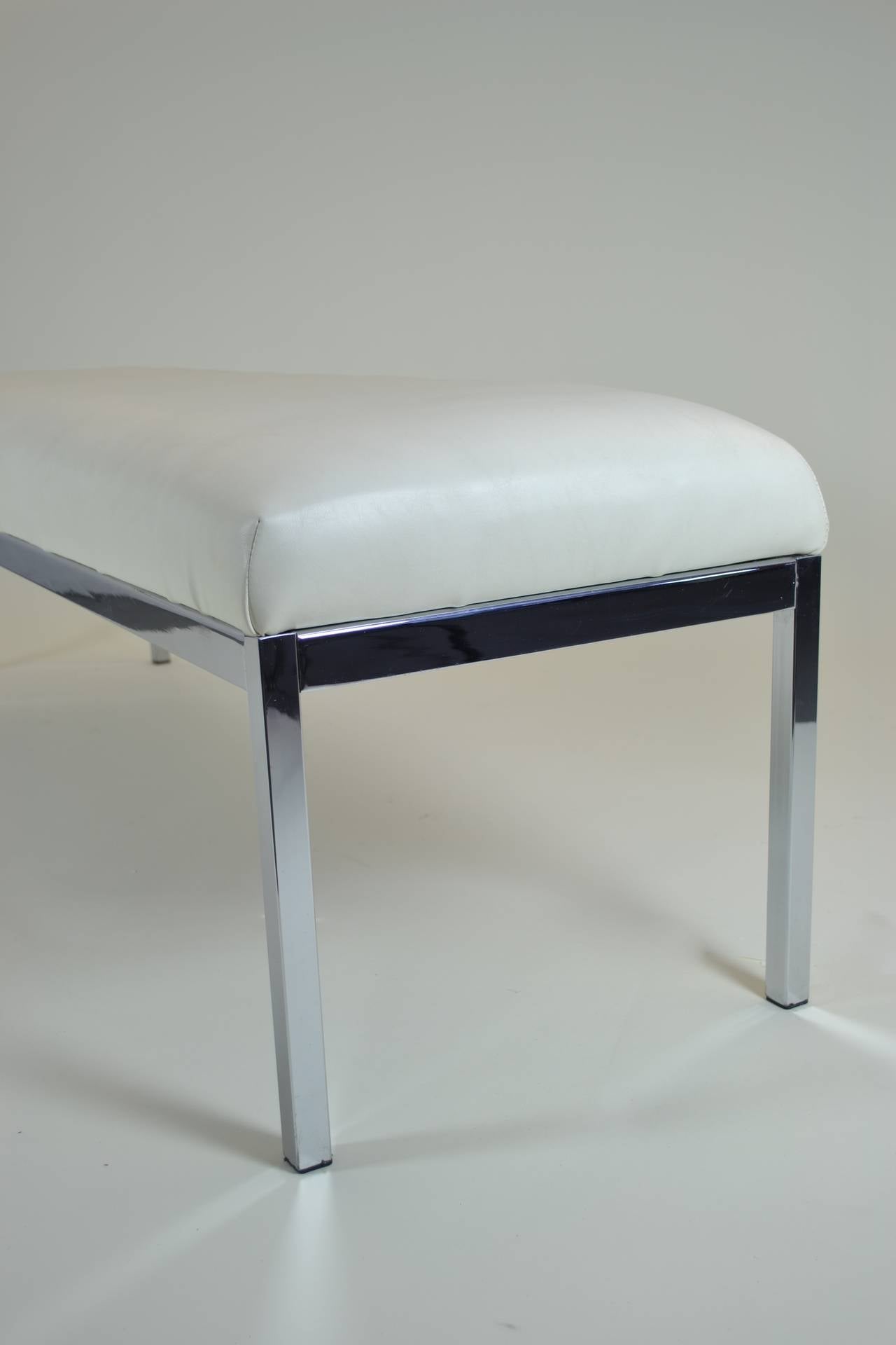 Simple chrome bench, upholstered in white vinyl. Nice proportions.