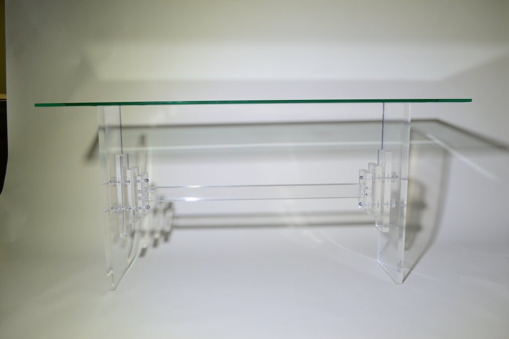 Sculptural Lucite base with heavy beveled glass top.