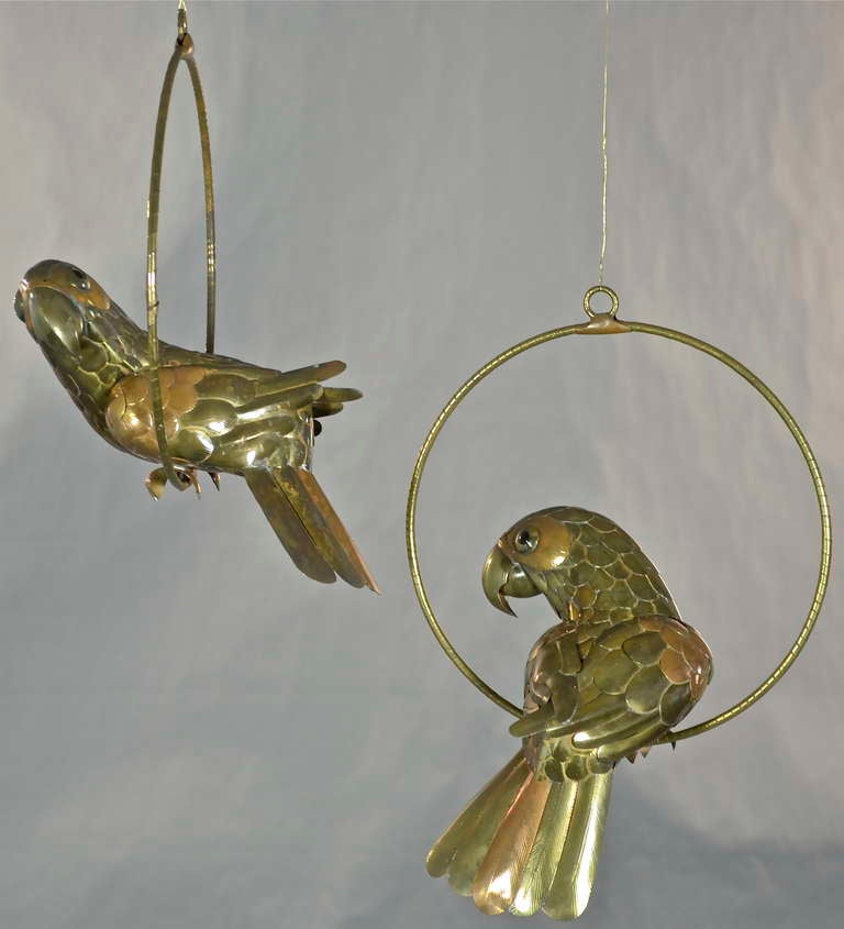 Two charming parrot on perch sculptures by noted Mexican artist, Sergio Bustamante. Intricately crafted from brass and copper with amazingly realistic glass eyes. Two available, priced at $985.00 each.