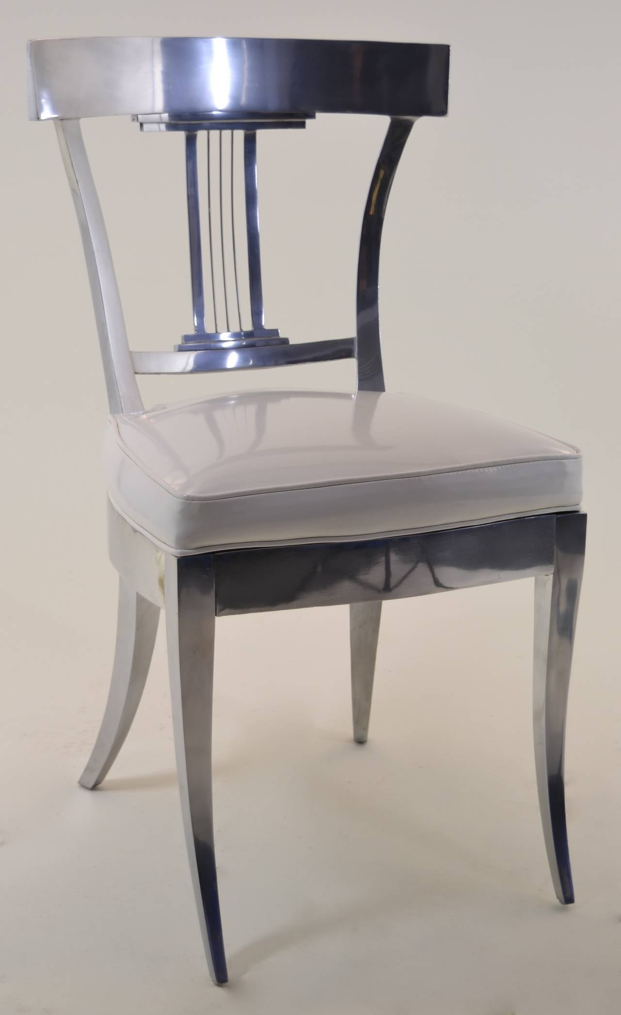 Quality cast aluminum side chair in polished aluminum with fitted boxed seat, newly upholstered in patent 