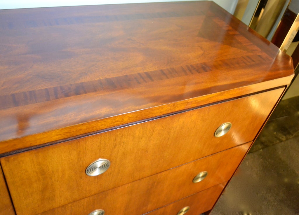 A handsome mahogany double dresser by Baker Furniture, designed by Charles Pfister. Featuring sleek flush mounted pulls that push in to make handles. Top has subtle parquetry design. Light mahogany finish is very elegant.