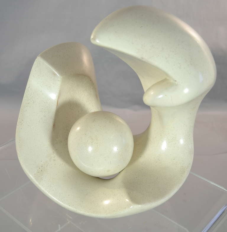 Smooth stone finish in a biomorphic form with free floating sphere nested in center. Great size. 