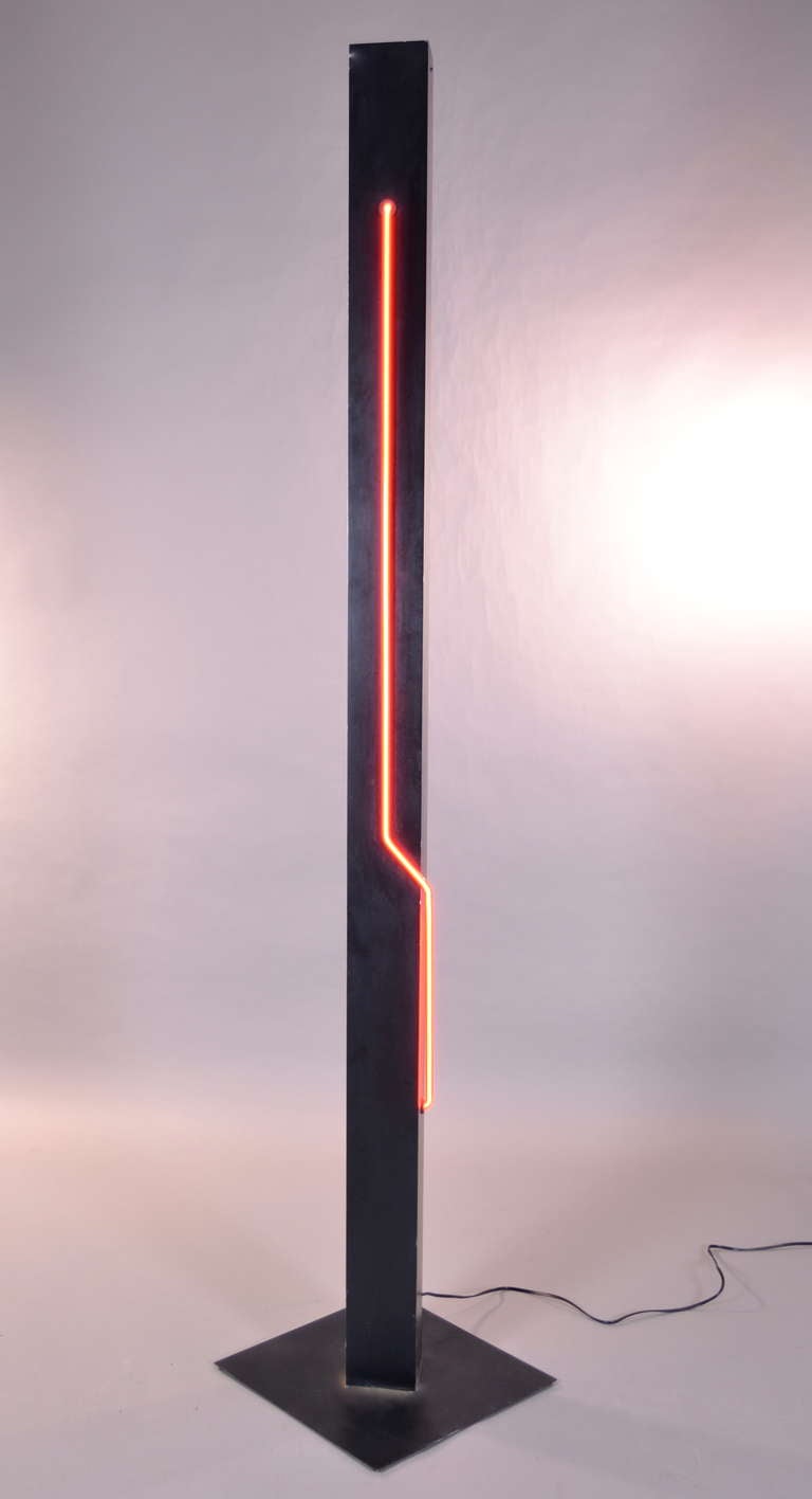 Designed and manufactured in the1970s by George Kovacs, a super statement floor lamp featuring a neon element as well as a torchiere-style up light. Seperate controls --a dimmer for the uplight. Heavy iron base and cast aluminum plinth --all
