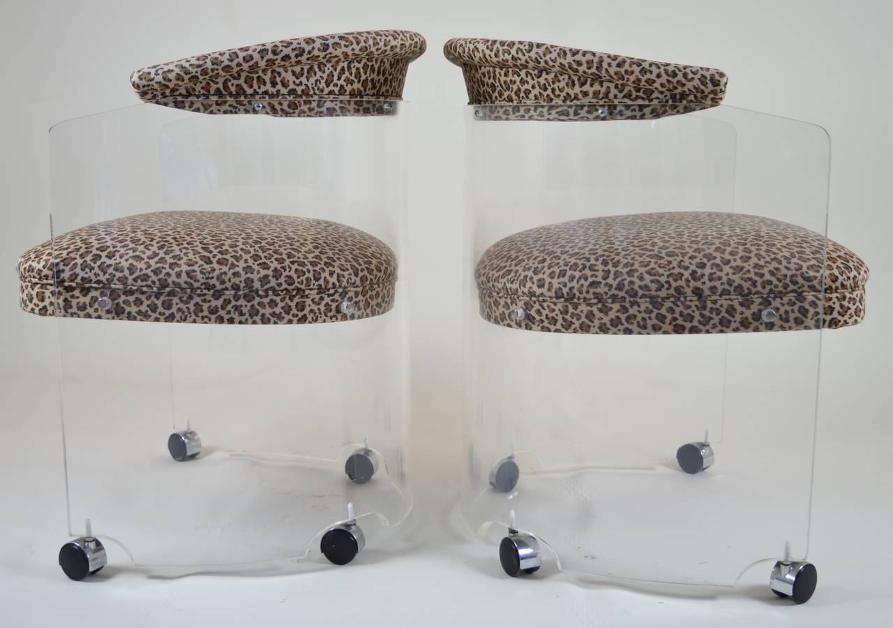 Super fun barrel back chairs on casters with leopard print upholstery.