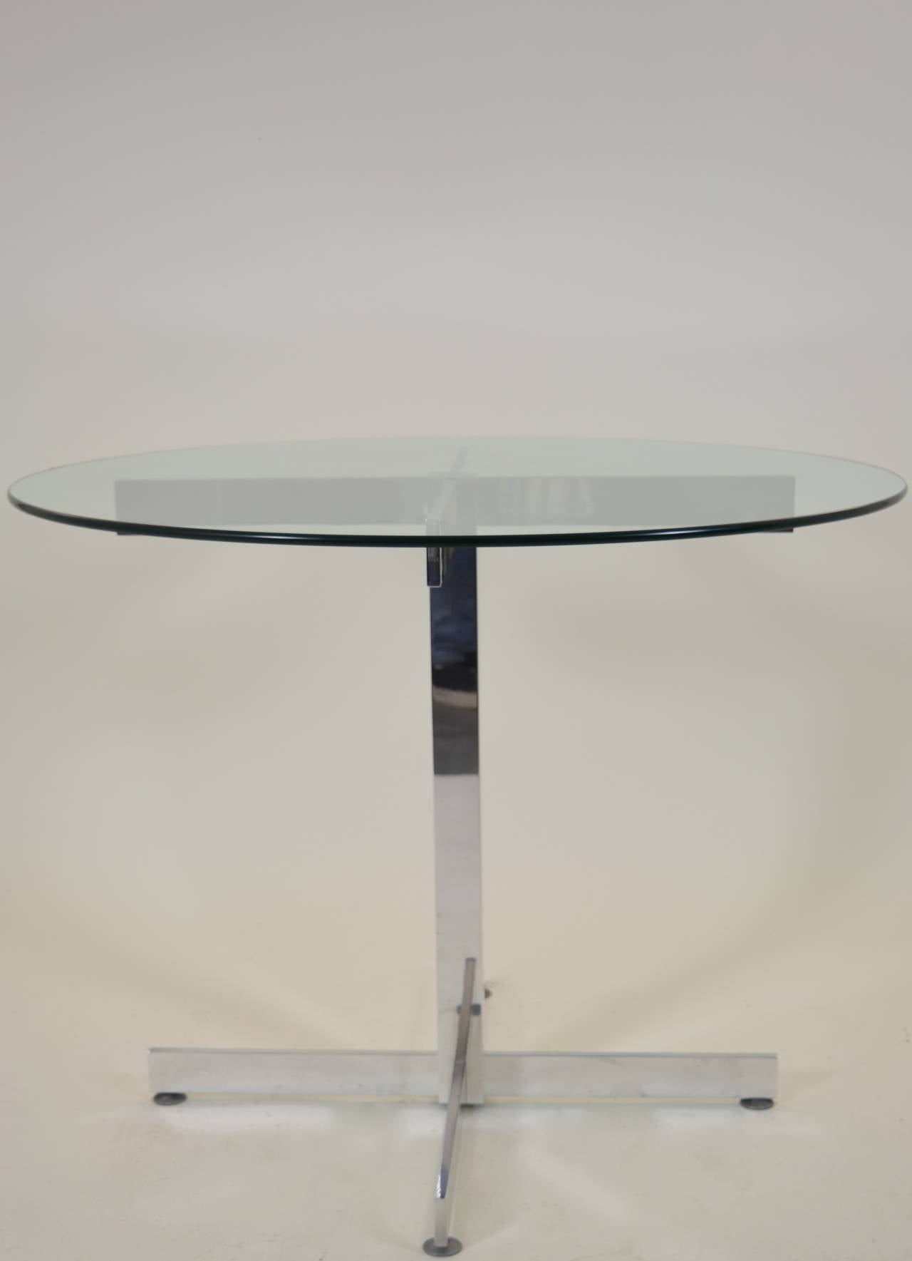 Perfect for a small dining or breakfast area; could even be a center or game table. Highly polished simple aluminum base with heavy glass top.