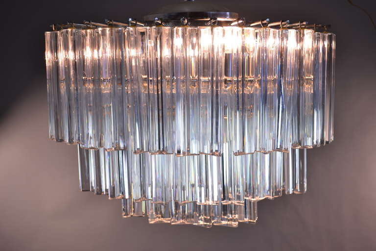 Very unusual and elegant eye-shaped form on this 3-tier chandelier. Versatile size --featuring two sockets that can take up to a 65 watt bulb each. in excellent condition.