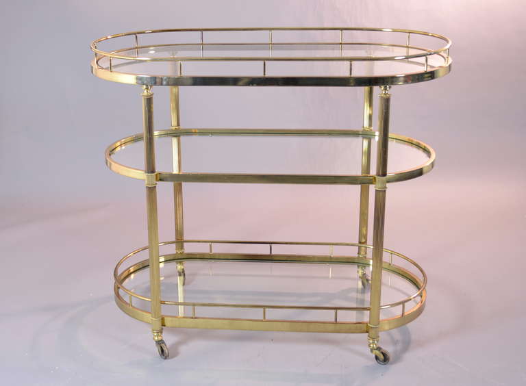 Three tier cart with polished brass finish. Nice railing details and all brass wheels.