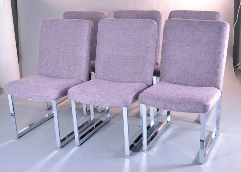 Designed in the early 1970s by Milo Baughman for Thayer Coggin. Newly upholstered in lavender chenille--on quality chrome bases with internal wheels --for easy movement in and out from a table. Excellent condition.