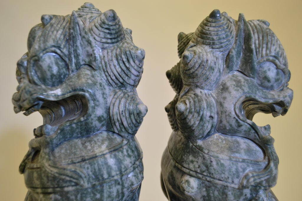 Handsome carved food dogs --a true pair in a very unusual striated stone. Wonderful whimsical (fierce!) expressions and geat heads. This item may be viewed at: The Antique & Artisan Center.
