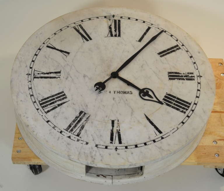 Originally a commerical clock for a bank or building lobby, this clock face is made of white marble with the original painted numerals. It is not functional although the works are still inside. 
