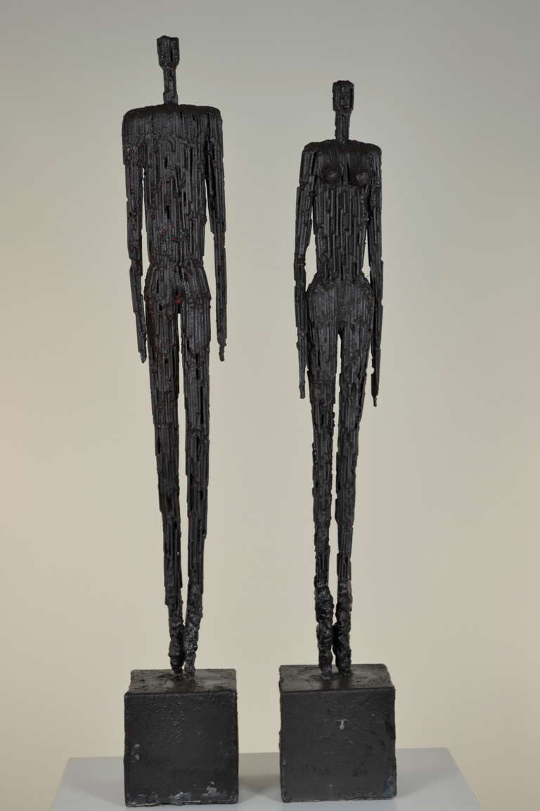 Forged iron sculptures --male and female. Each standing on a sel-base. He stands 27