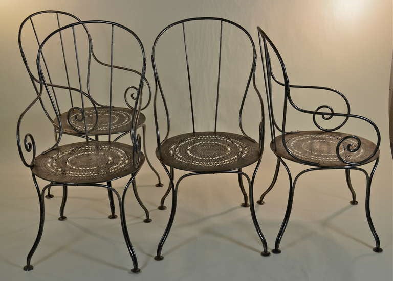 Polished steel French cafe chairs --all arms with wonderful curvy design and perforated patterned seats. Would be great indoors or out.