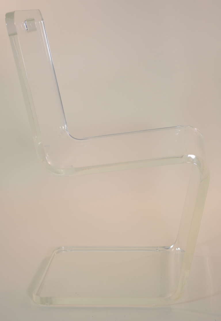 Super sleek in very thick fire polished Lucite, a stabile and comfortable side or desk chair. Excellent condition. Note the detail of handle at top of back.