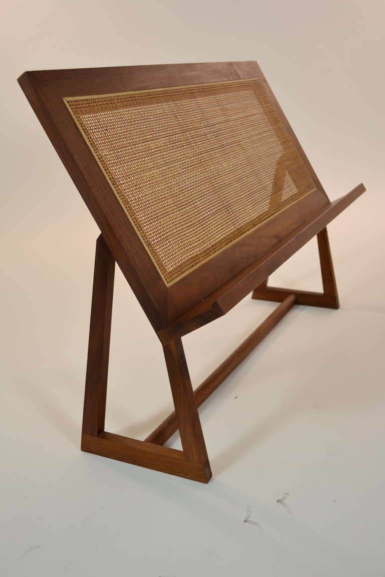 Sleek, modern design in teak and raffia --this book, magazine or music stand is unusually long --very stable and in excellent condition. Label on underside from Schreibe Products.