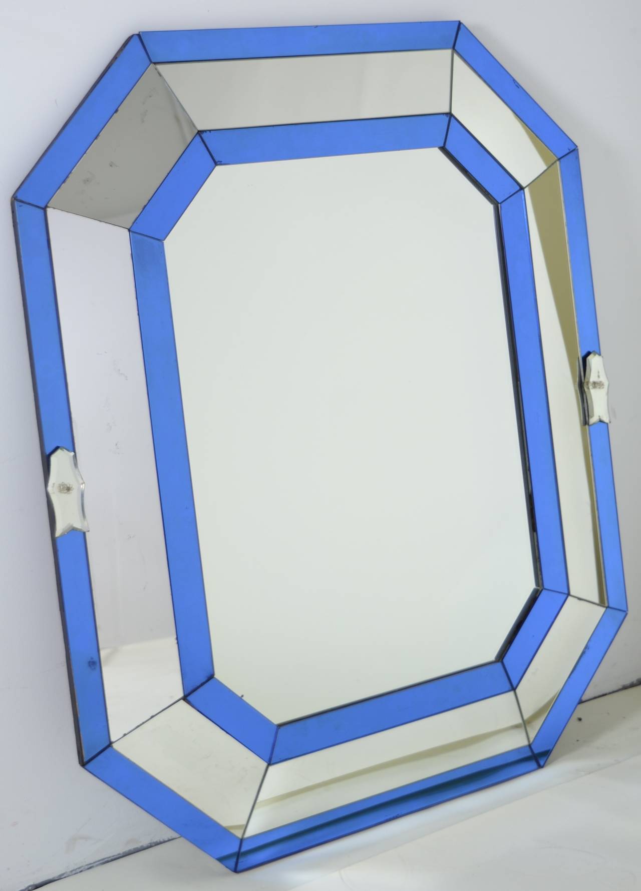 Vintage Continental mirror in octagonal form. Blue mirror makes is stand out. Surrounding glass in angled to fracture reflection. Nice size.