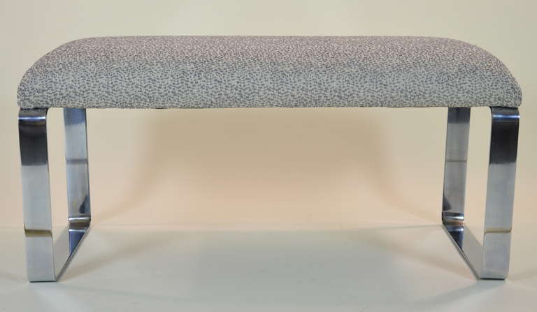 Simple, elegant bench with chrome legs. Newly upholstered top in subtly textured grey and white cover.