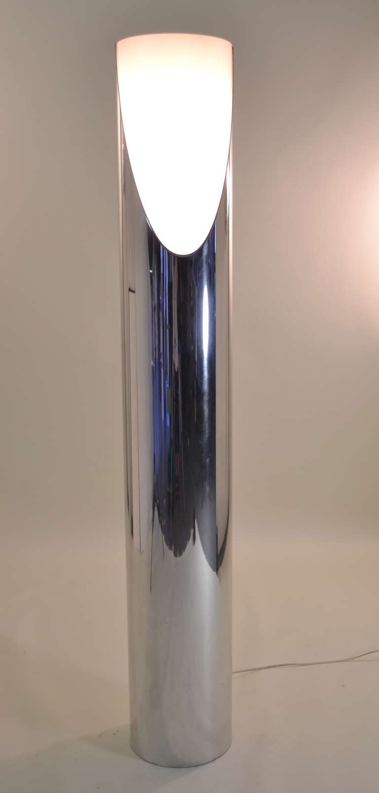 Cylindrical polished aluminum lamp with white lucite filter. Light has three settings: low, high and an uplight. Aluminum housing has been professionally polished to a wonderful sheen. Minor scratches but generally excellent condition.