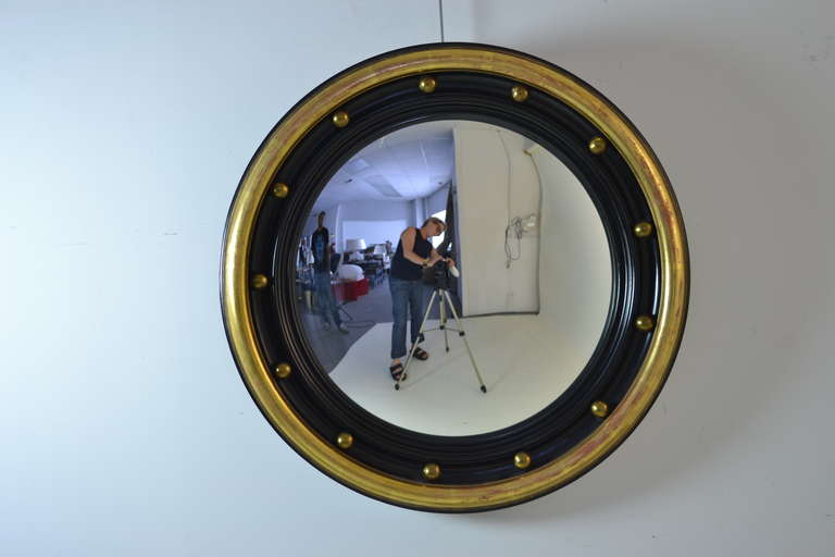 Beautifully patch gilding combined with black --Federal style convex glass mirror, circa 1900 - 1920 with NY label on verso.
