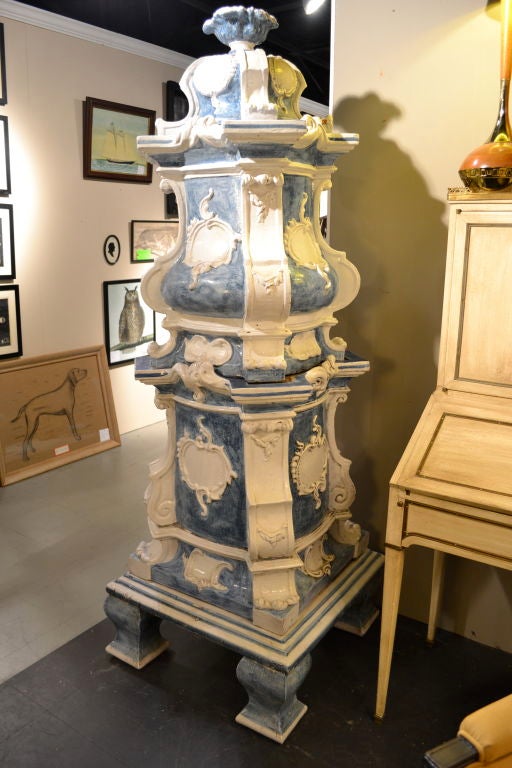 A monumental and highly decorative stove made of thick terracotta with rococo decoration and a charming blue and white glaze, standing over six feet.  This piece was purchased by a U.S. diplomat from an antiques shop in London decades ago. It is in