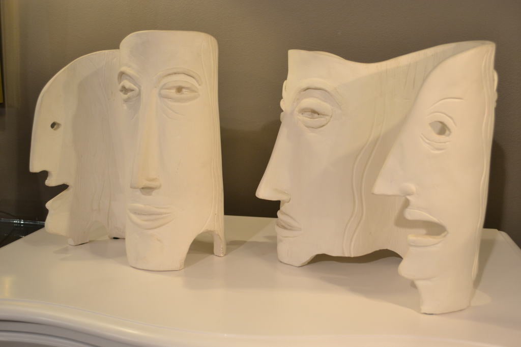 Fascinating sculpture showing both abstract and semi-realistic faces in composition of curves in ceramic, signed 