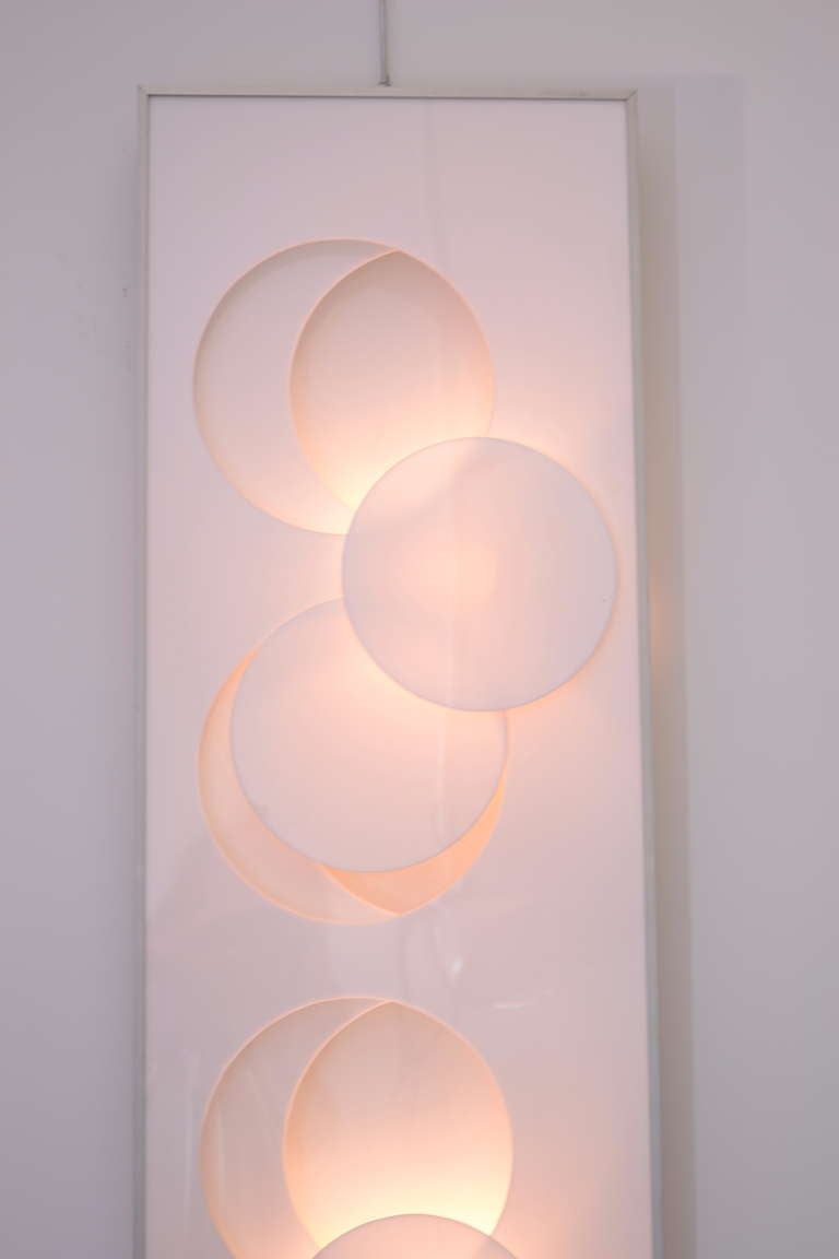 A lighted wall sculpture signed and numbered by artist American David Steele. Constructed of layered plexiglass panels in a cast aluminum frame and lighted with small interior bulbs.