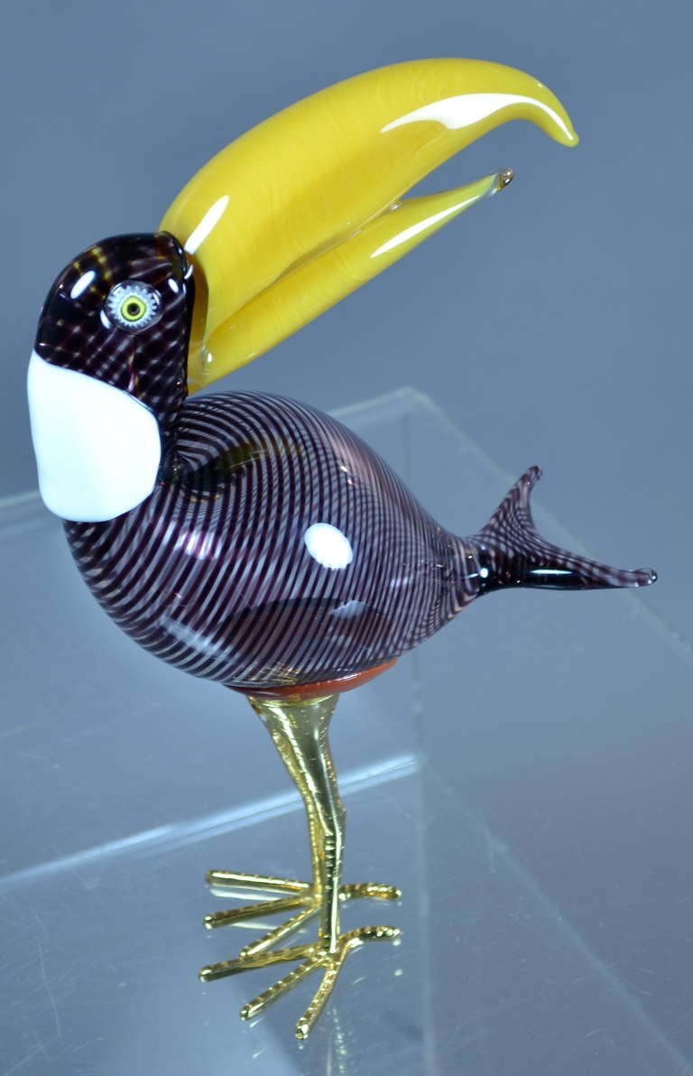 Completely fun --Toucan on gilded metal legs --finely crafted from mand blown Murano glass. Featuring jewel-like eyes and transparent body. Signed Zanetti, Italy, circa 1980s.